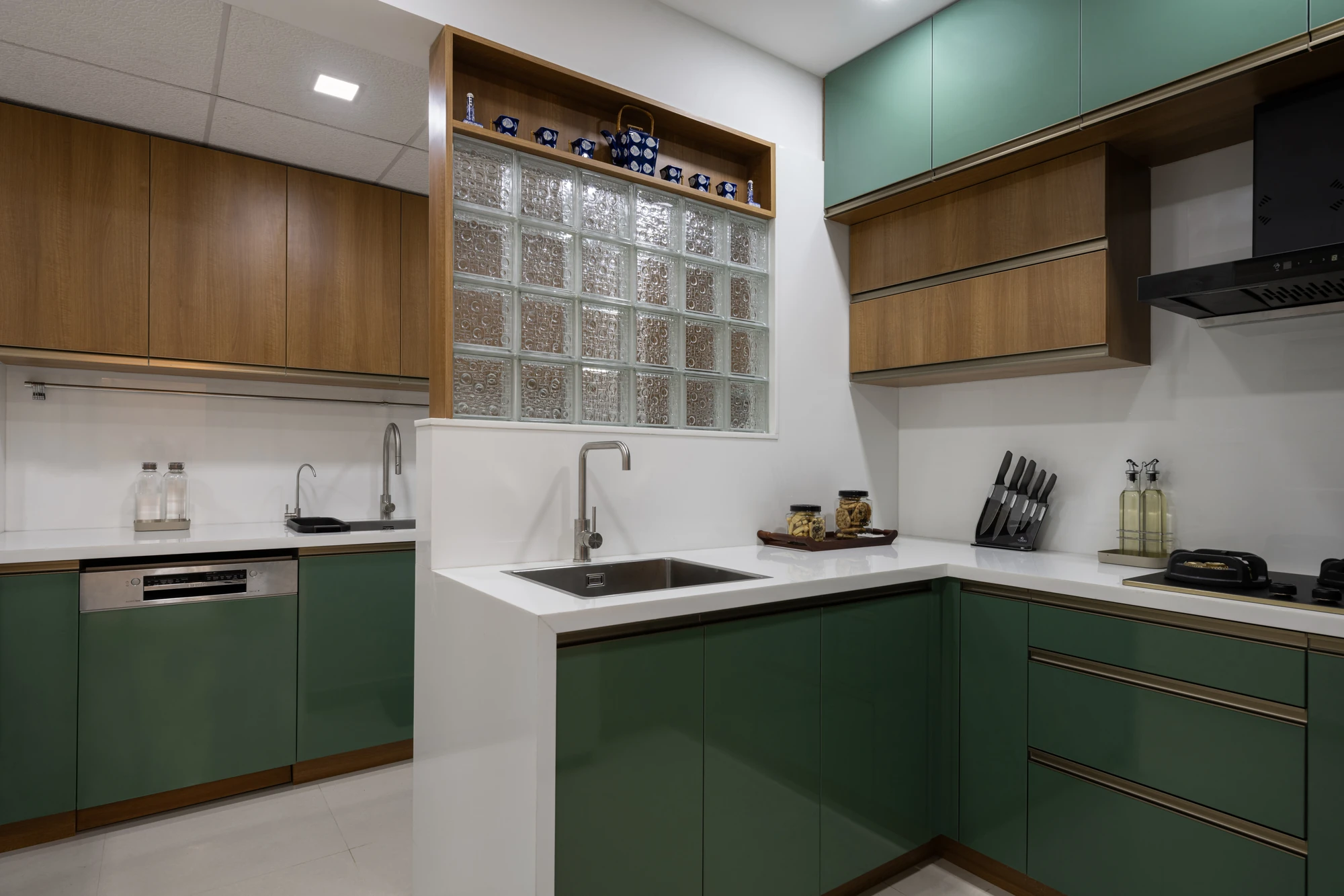 Modular kitchen in green and wood finish by Space Decor